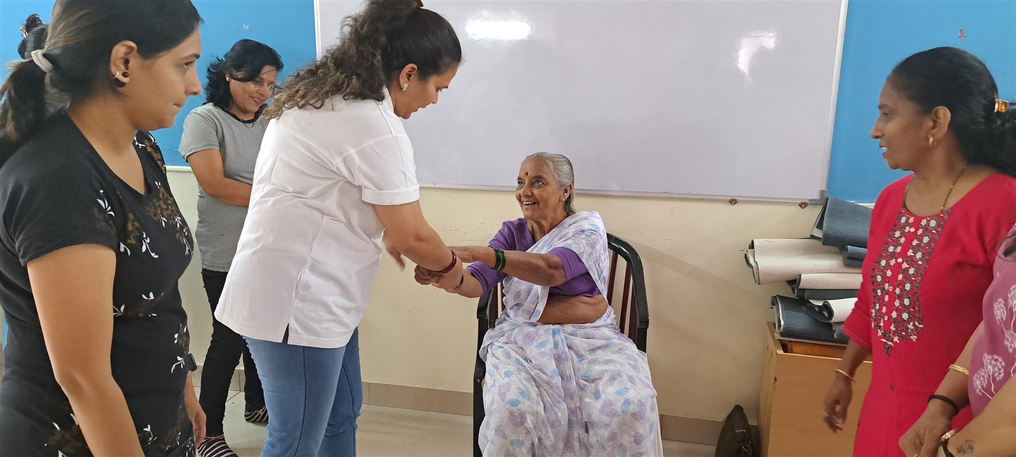 A senior citizen trying to release her wrist from a strong grip as a part of the self defence training
